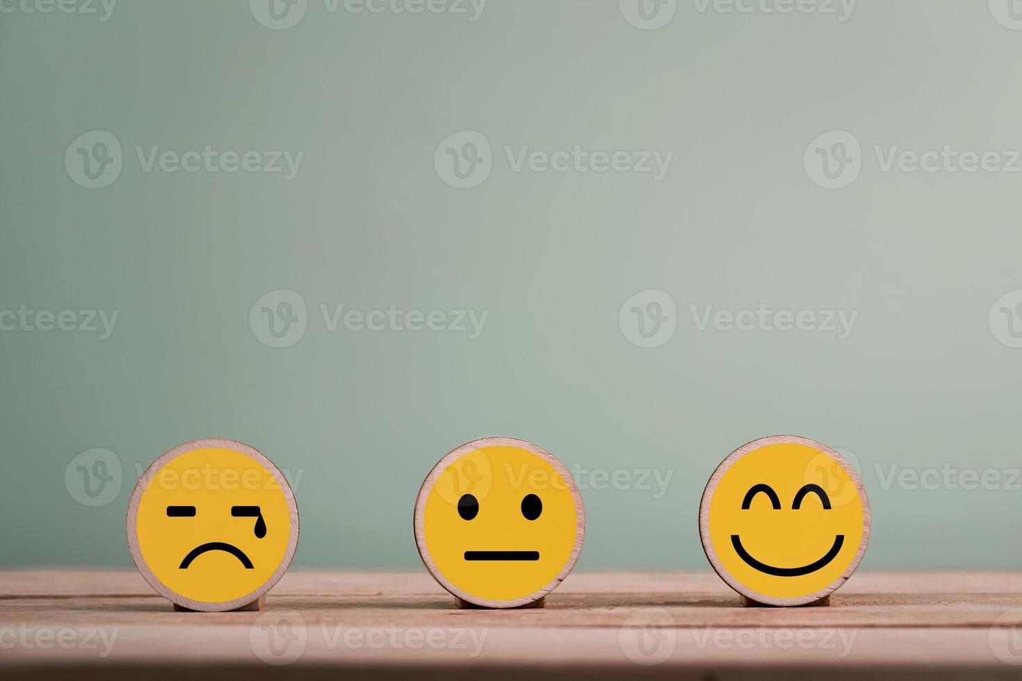 Happy smile face emoticon icons on Wooden Cube , good feedback rating for customer review survey photo