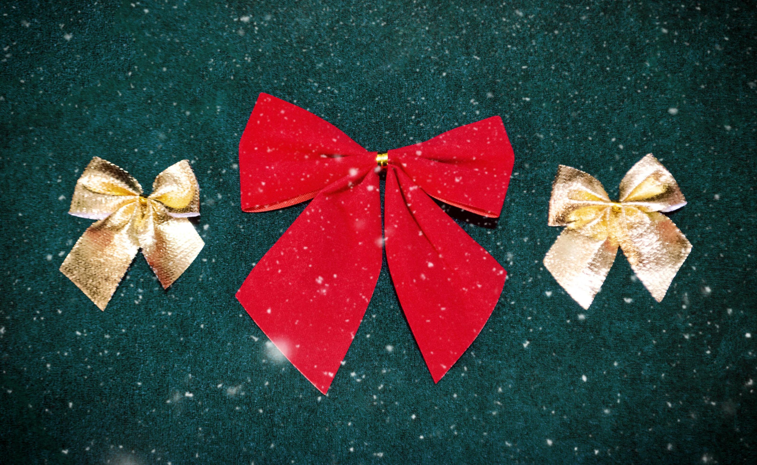 red and golden bows for Christmas tree decoration on dark green
