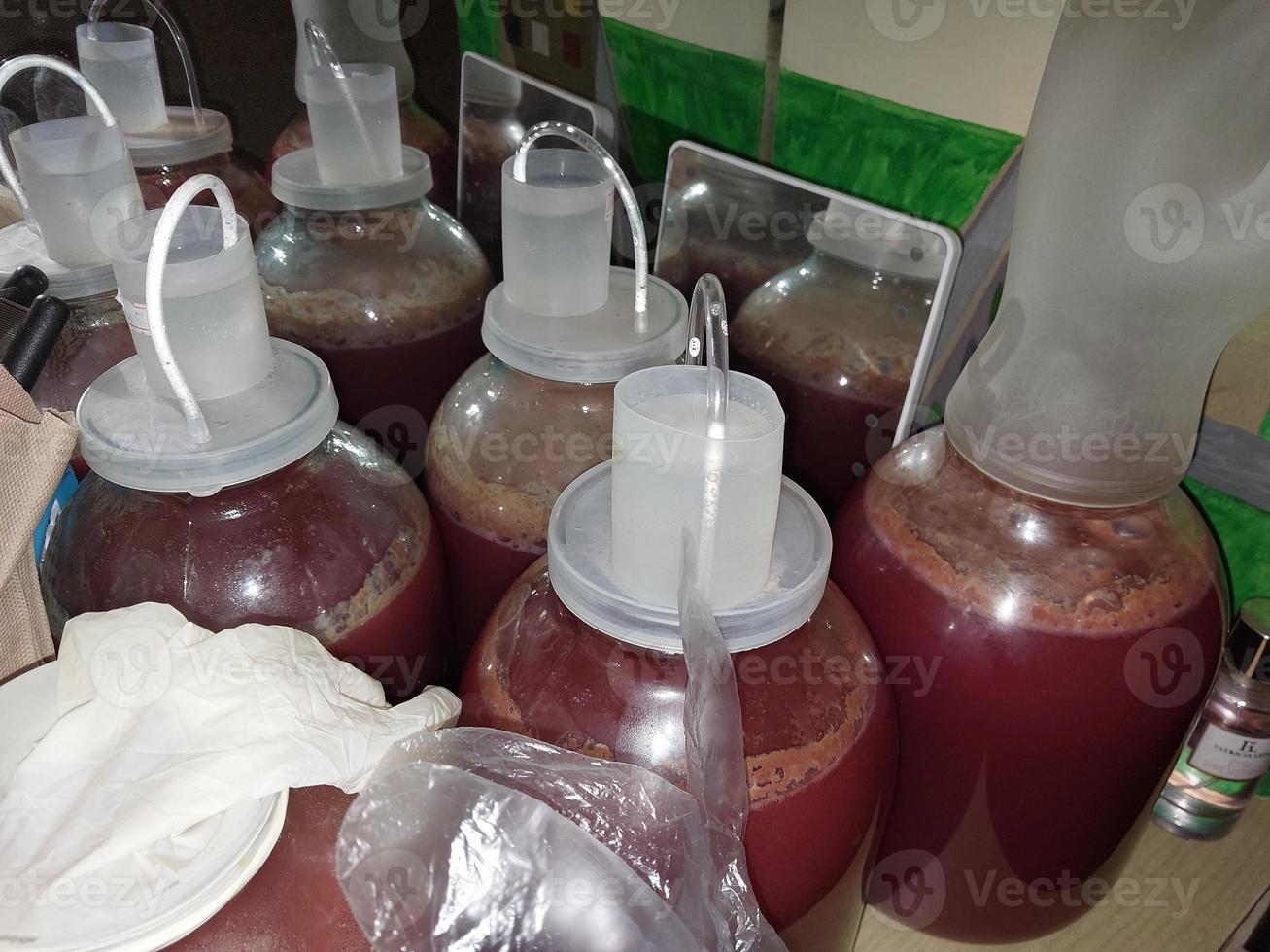 Fermenting homemade wine in cans closed with a water seal photo