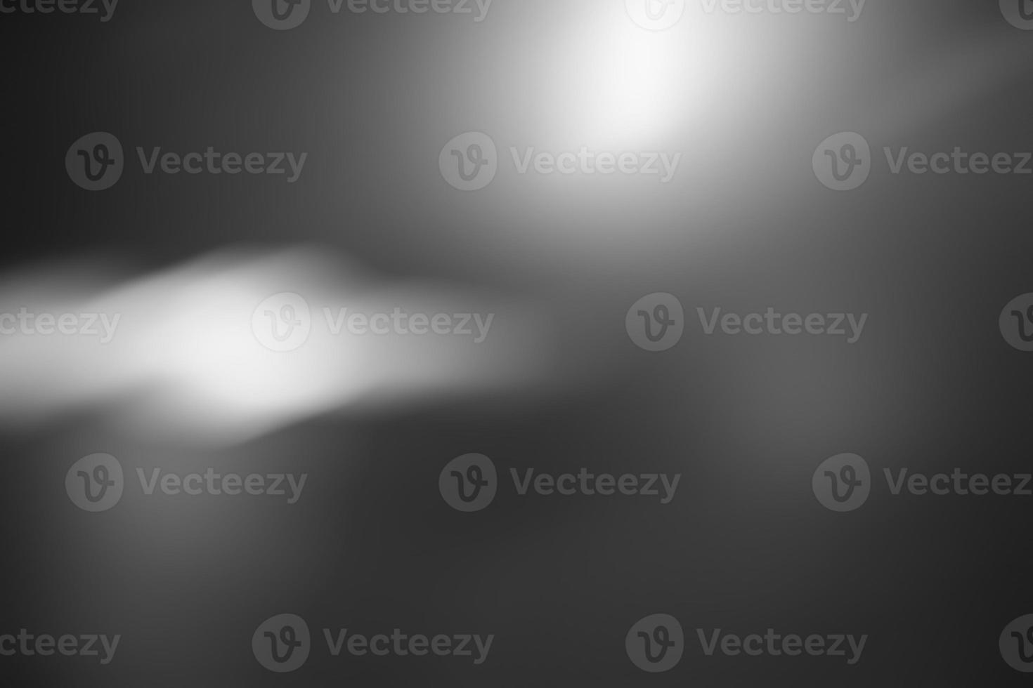 Defocus blurred abstract dark gray gradient spotlight floor texture background. Dark gray with shining background. photo