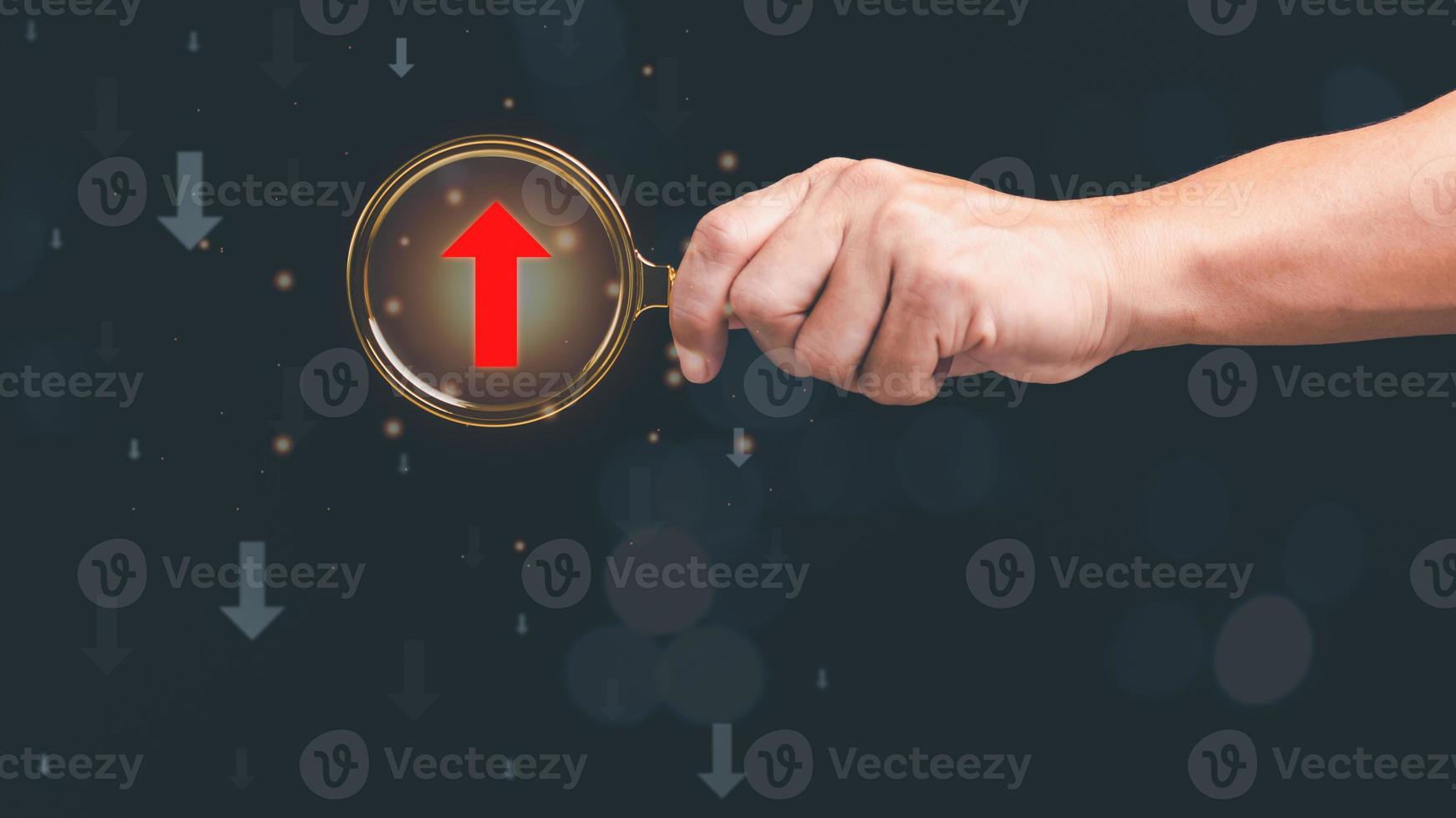magnifying glass in human hand, red arrow icon show the difference , concept of leadership and the growth of business competition ,Changes in strategy vision for a chance of success over competitors photo