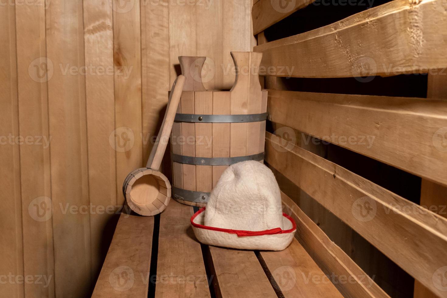 Traditional old Russian bathhouse SPA Concept. Interior details Finnish sauna steam room with traditional sauna accessories set scoop felt. Relax country village bath concept. photo