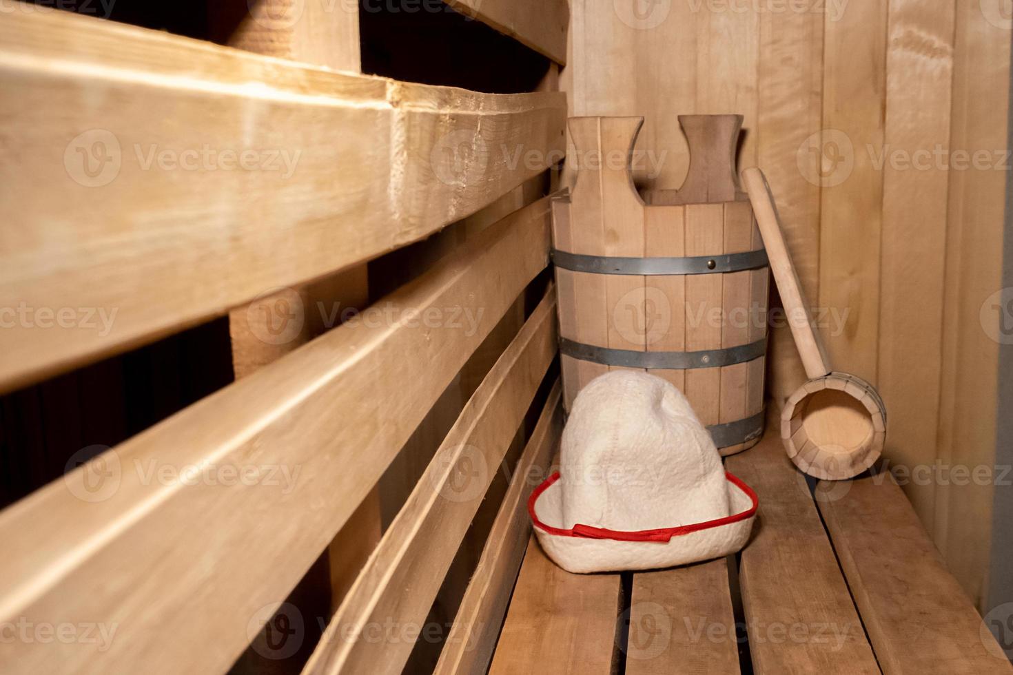 Traditional old Russian bathhouse SPA Concept. Interior details Finnish sauna steam room with traditional sauna accessories set scoop felt. Relax country village bath concept. photo