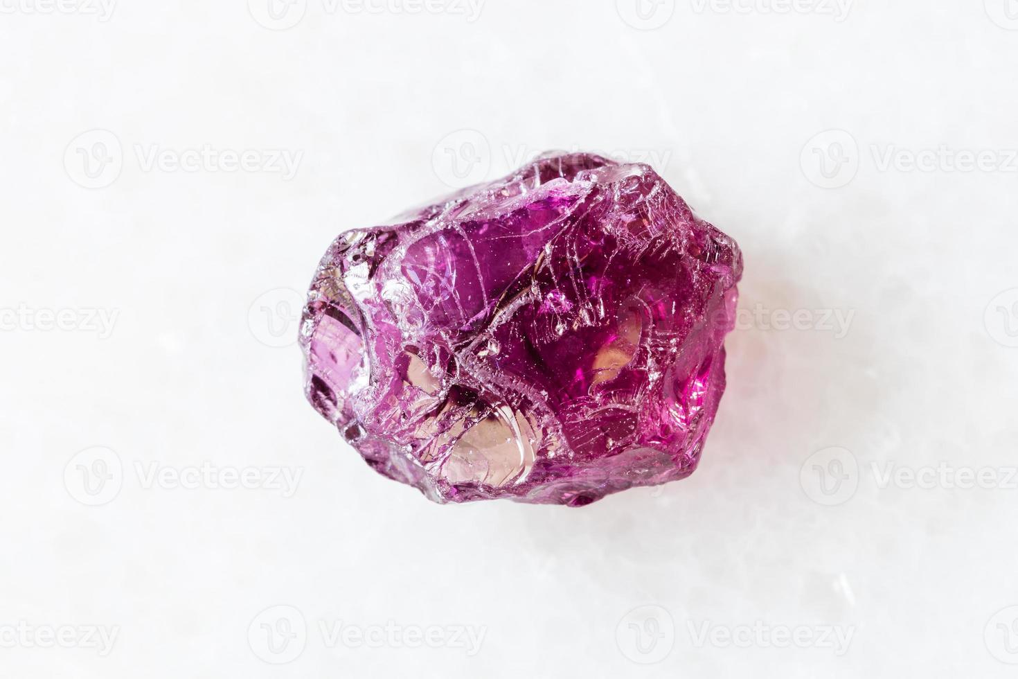 rough Rhodolite pyrope garnet crystal on white photo