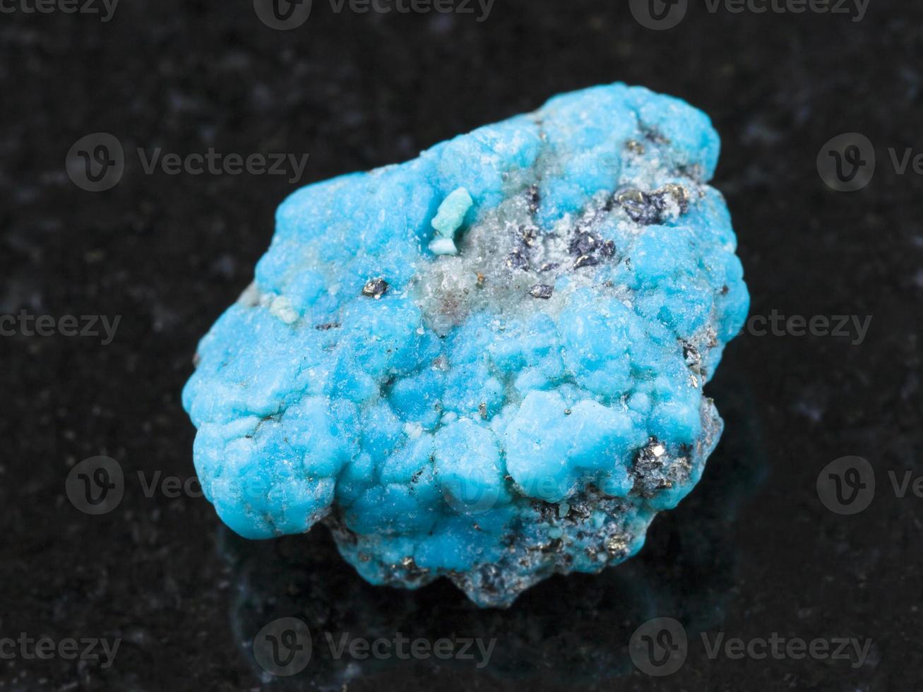 rough blue Turquoise gemstone on dark photo