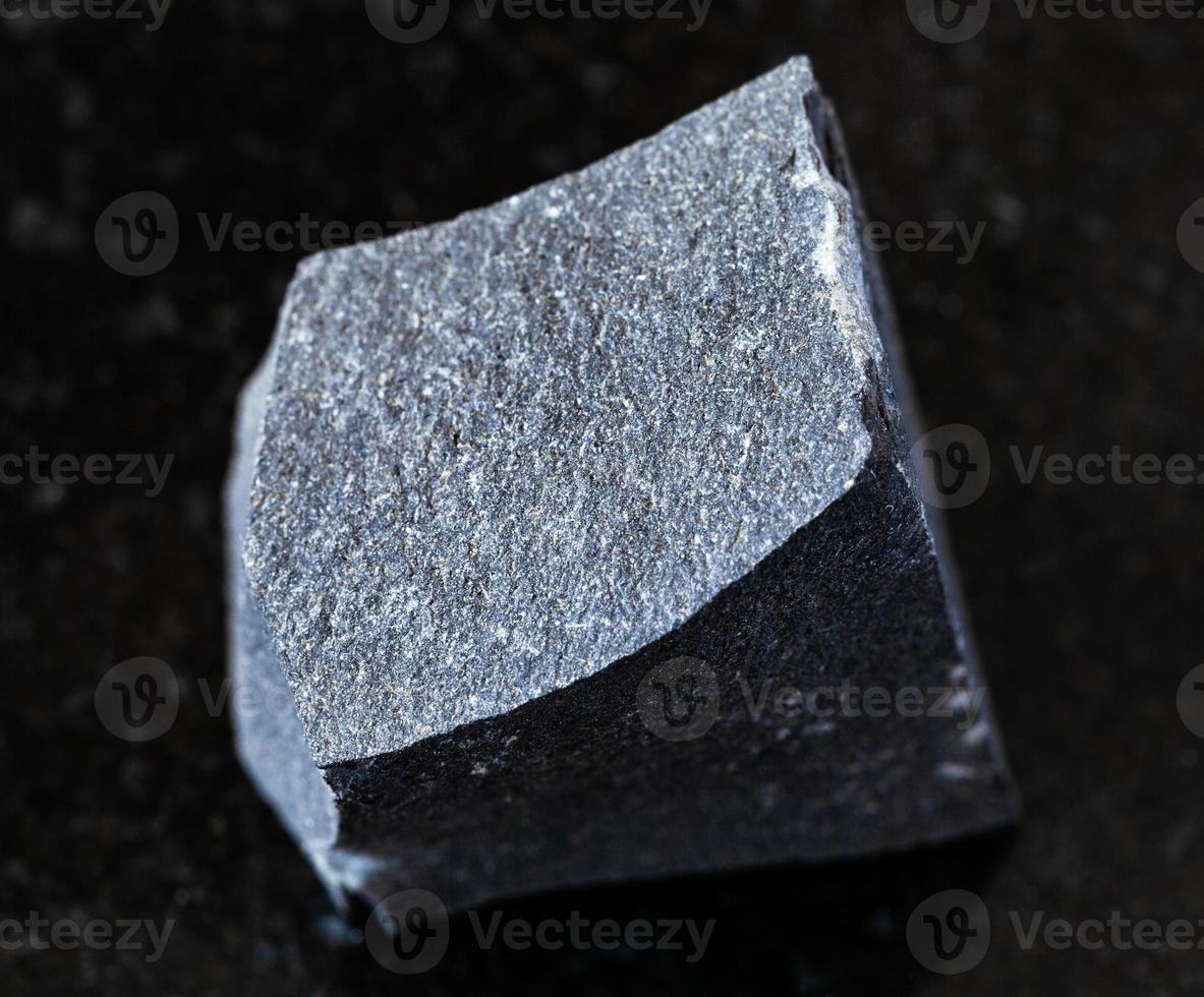 rough Hyalobasalt rock on black photo