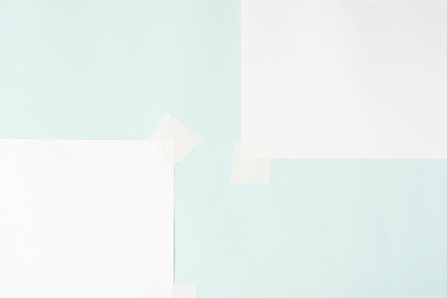 Two blank sheets on scotch tape, layout. White sheets of paper on pastel blue background, copy space photo