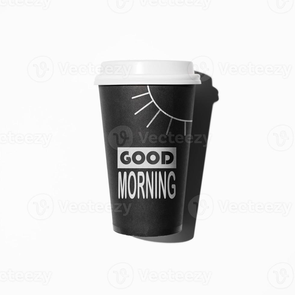 Disposable coffee cup, flat lay. Hand drawn Sun and text Good Morning on the glass. Invigorating drink in the morning concept photo