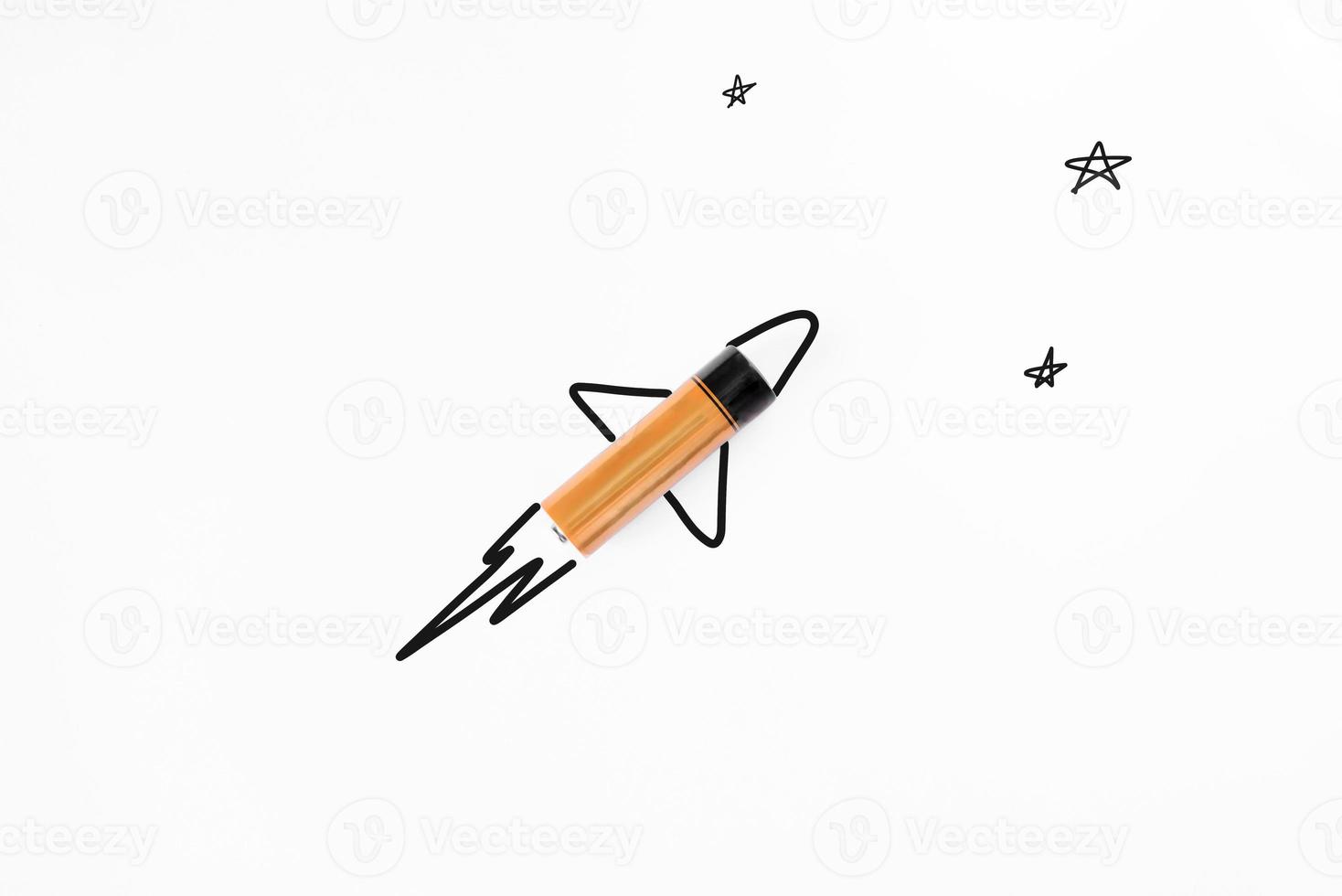Alkaline battery is like a rocket flying into space. Powerful battery creative concept. White background, flat lay. photo