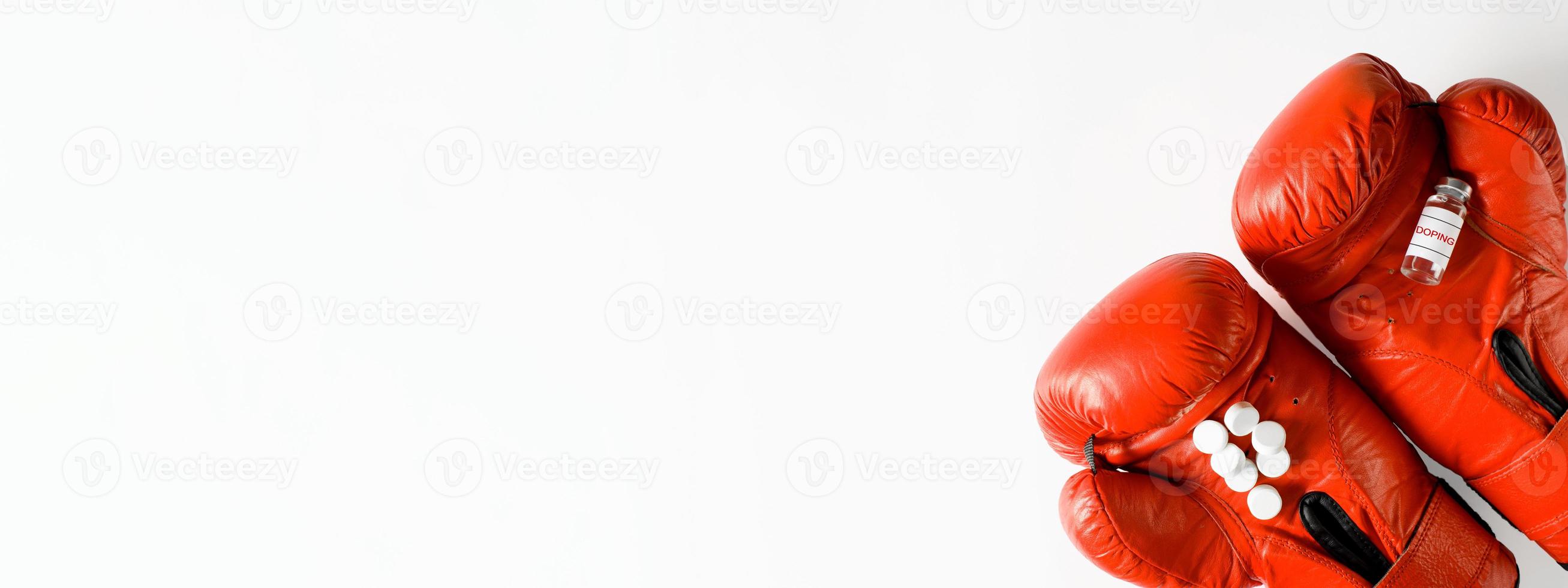 Vial of a prohibited substance, pills and boxing gloves on a white background, flatlay. Banner with place for text. Competition doping, pharmaceuticals and sports concept. photo