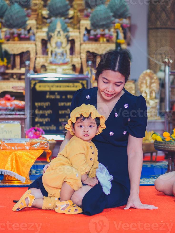 Asian mother and son of Thai nationality in temple at Thung Saliam temple or Wat Thung Saliam, Thung Saliam, Sukhothai, Thailand. photo