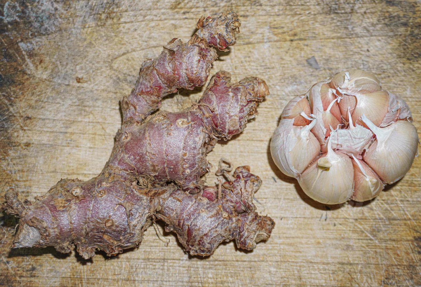 Red ginger on a wooden cutting board. selective photo of ginger spice on a wooden board