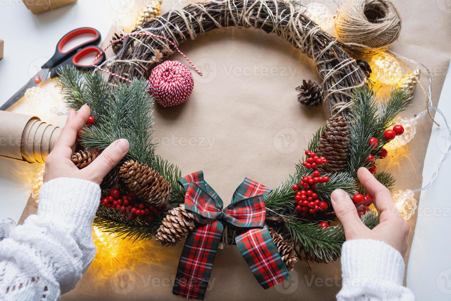 Making a Christmas wreath with your own hands. Holiday preparation, home decoration, New Year photo