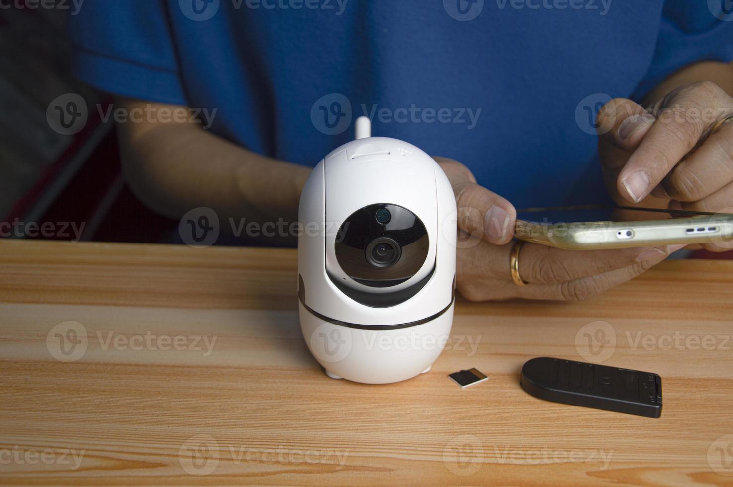 Conceptual man operating ip camera photo