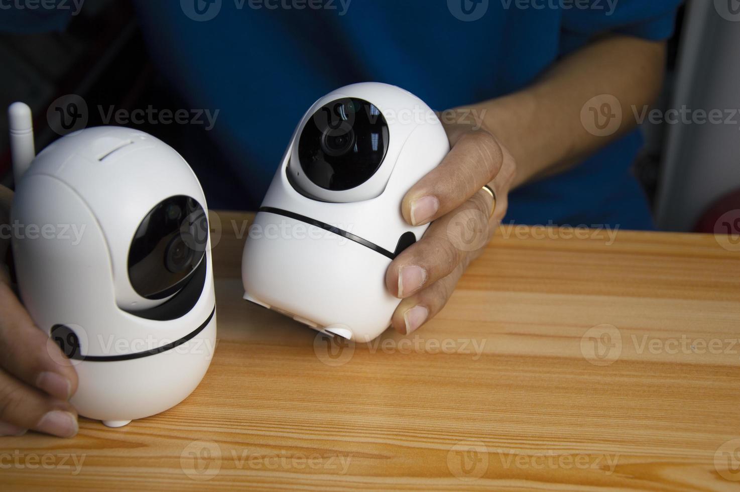Conceptual man operating ip camera,White IP cameras, very popular for security purposes. photo
