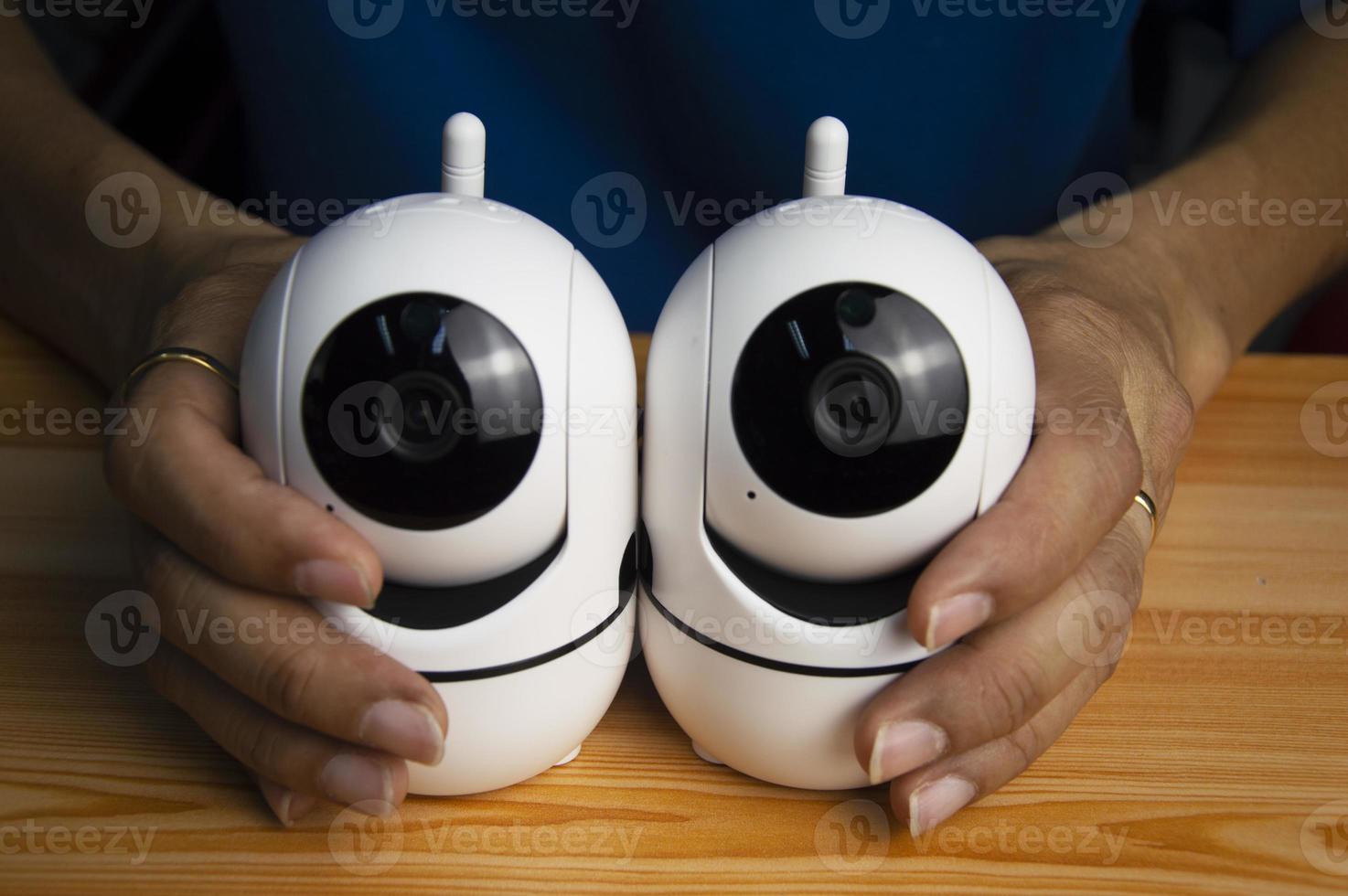 Conceptual man operating ip camera,White IP cameras, very popular for security purposes. photo