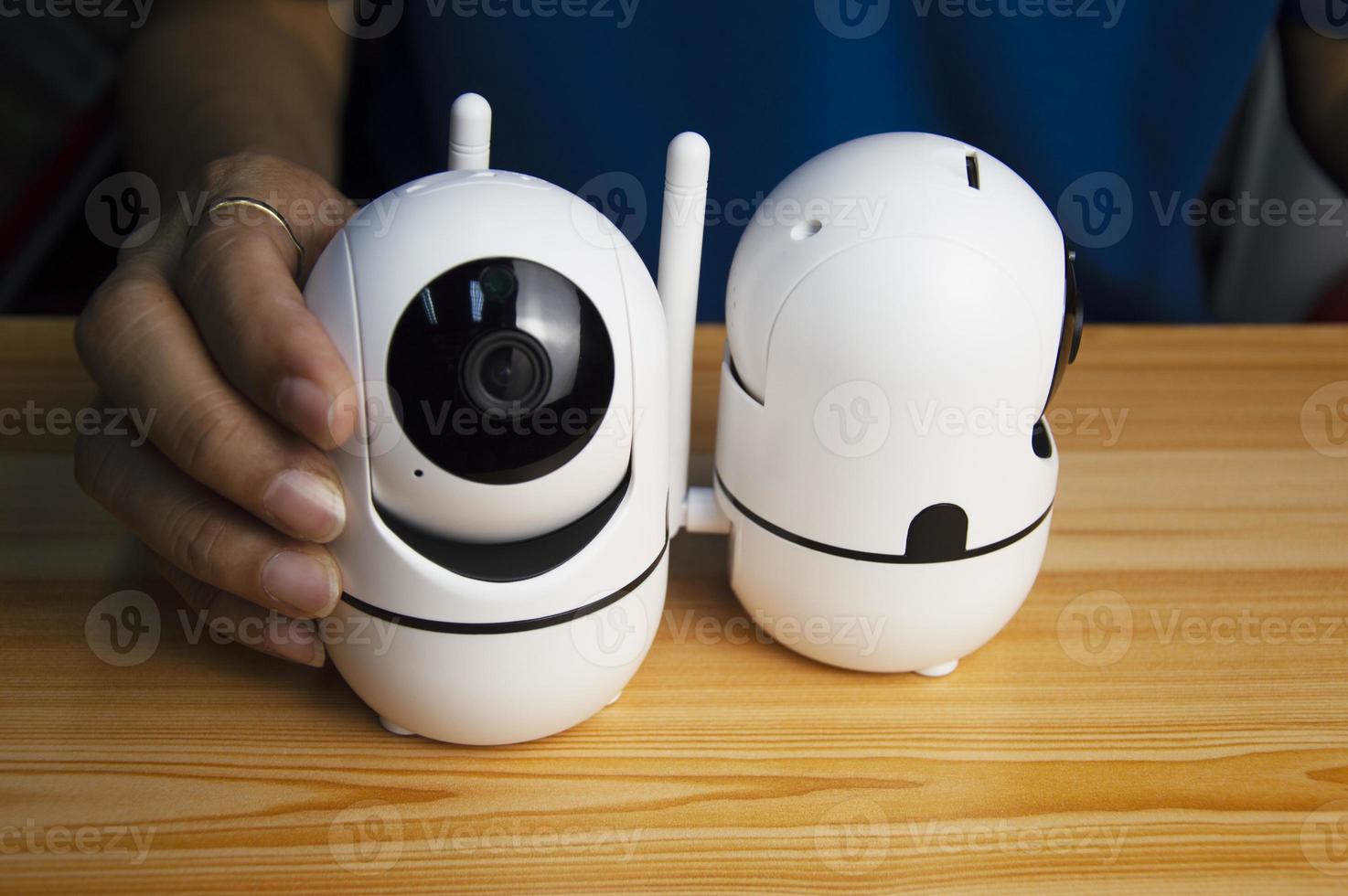 Conceptual man operating ip camera,White IP cameras, very popular for security purposes. photo