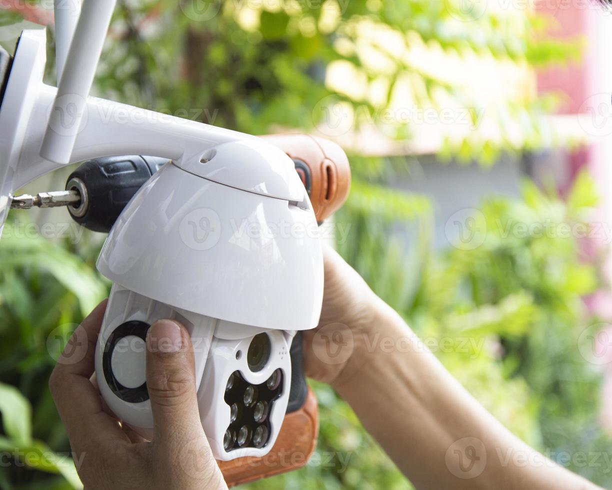 Man installing IP CCTV or high tech surveillance system CCTV system photo