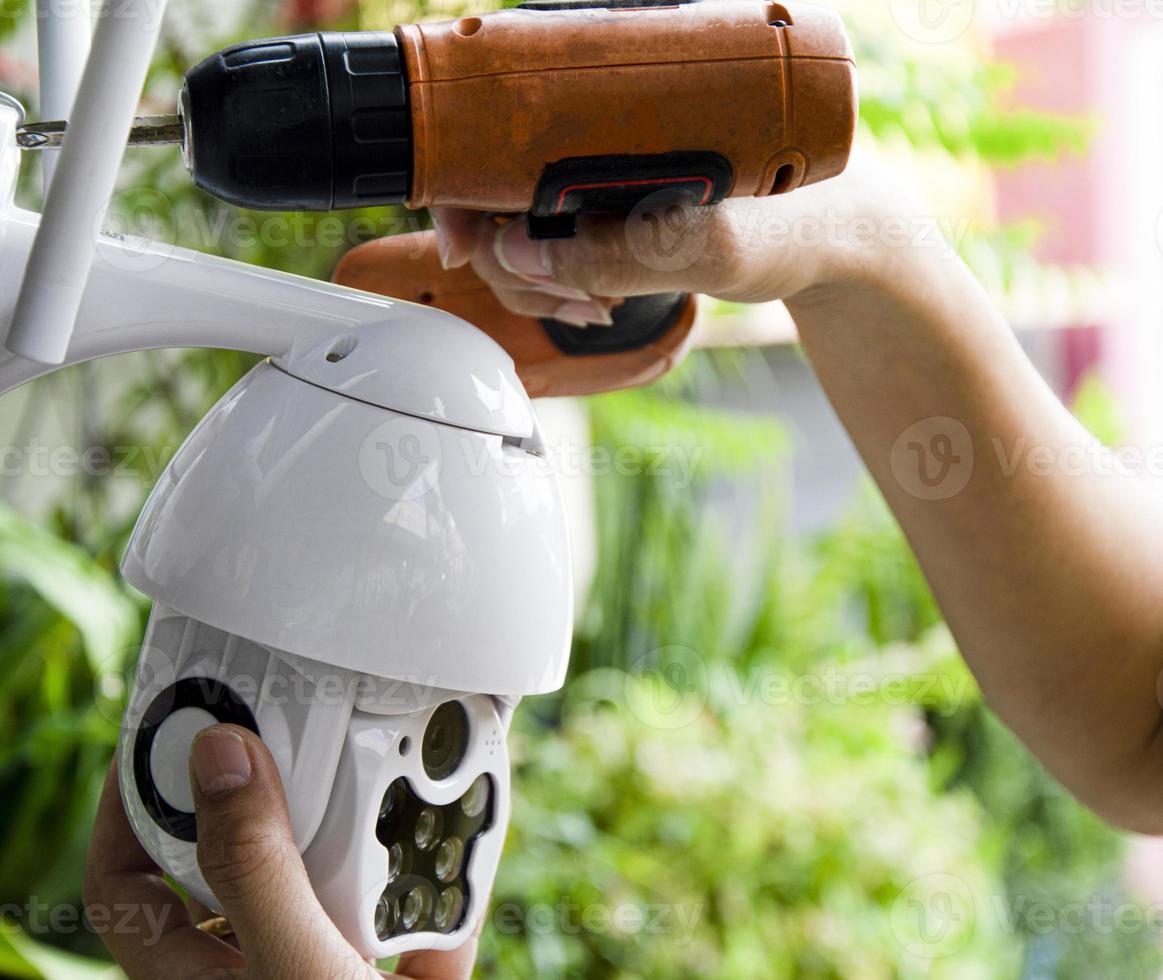 Man installing IP CCTV or high tech surveillance system CCTV system photo