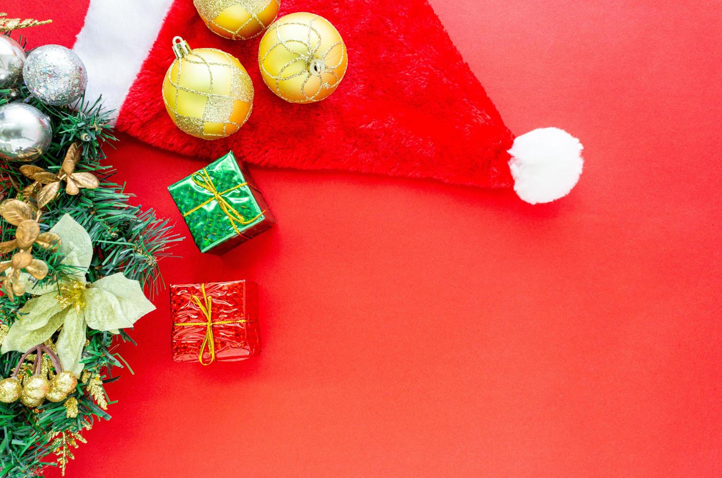 Christmas background, gold ornament ball and gift boxes on red background with copy space in top view photo