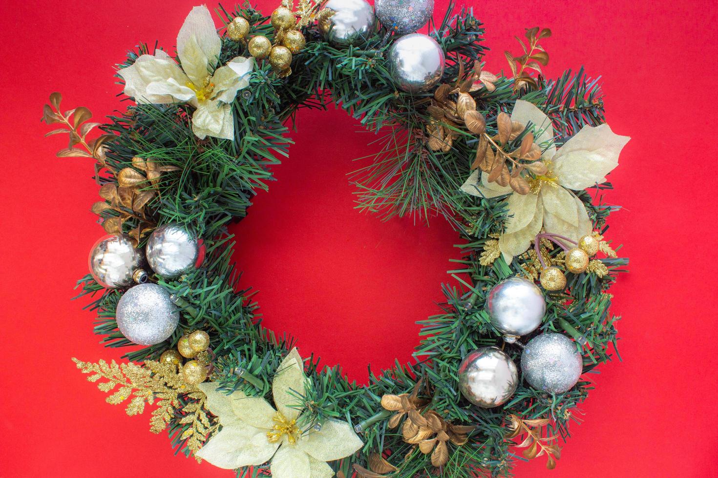 Christmas wreath on red background with copy space in top view photo