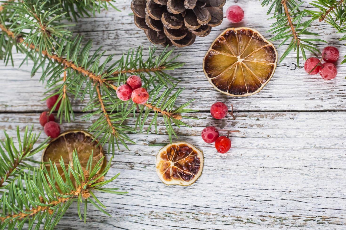 Christmas branches with cones viburnum berries and dry lemon slice photo