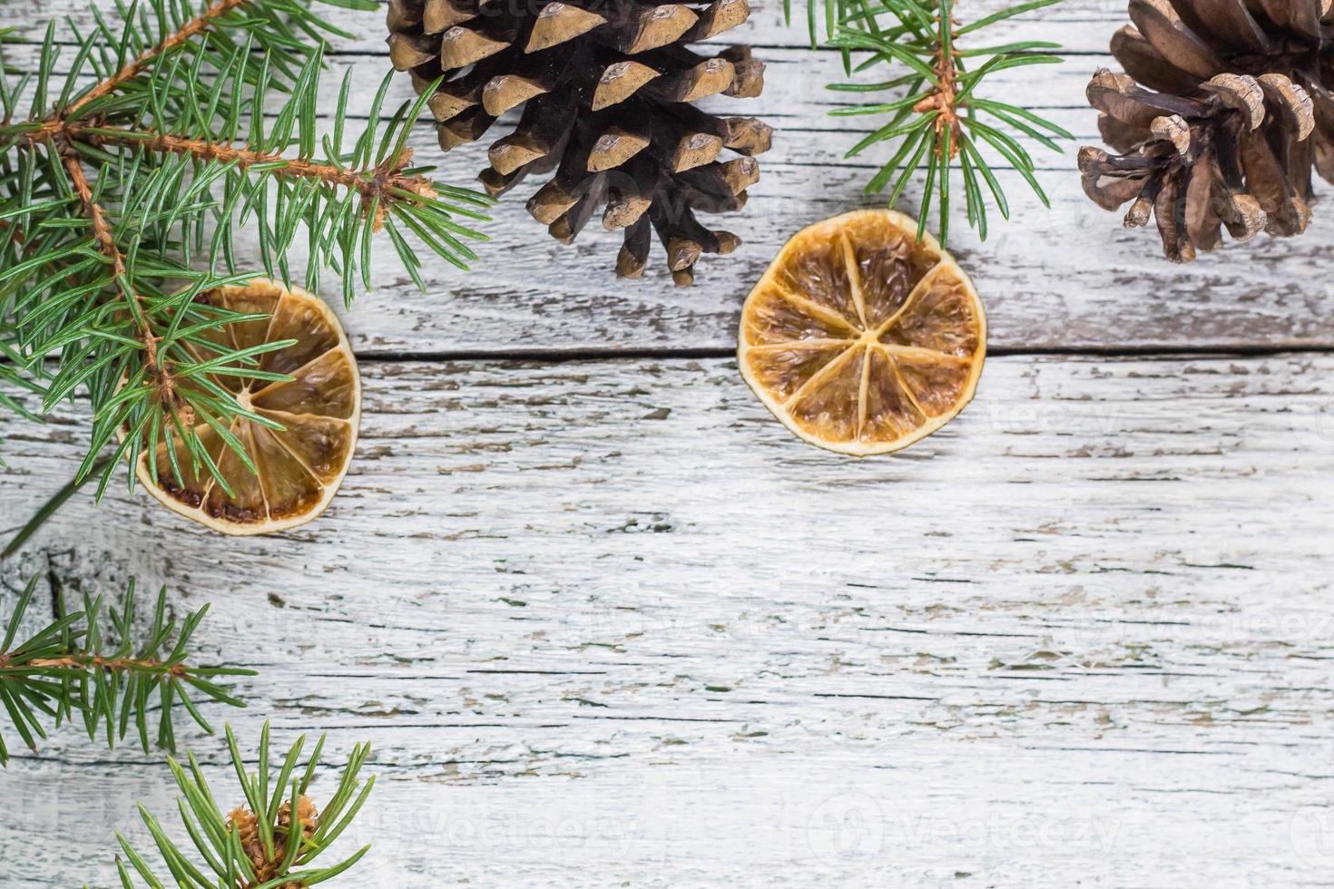 Christmas fir branches with cones and dry lemon slice photo