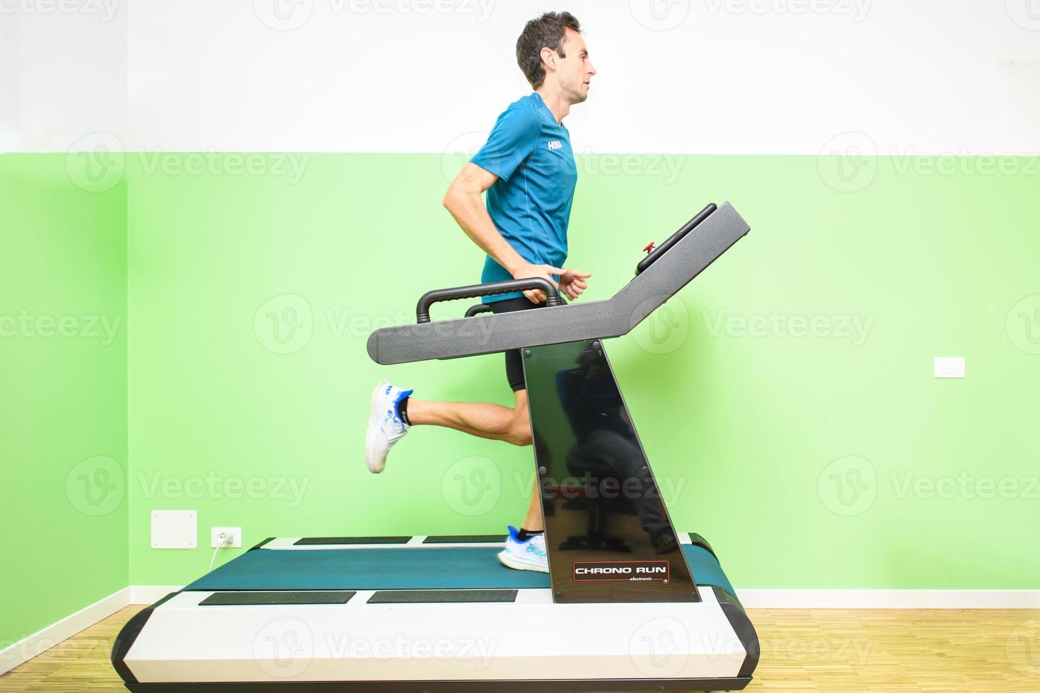 Male athlete trains on treadmill photo