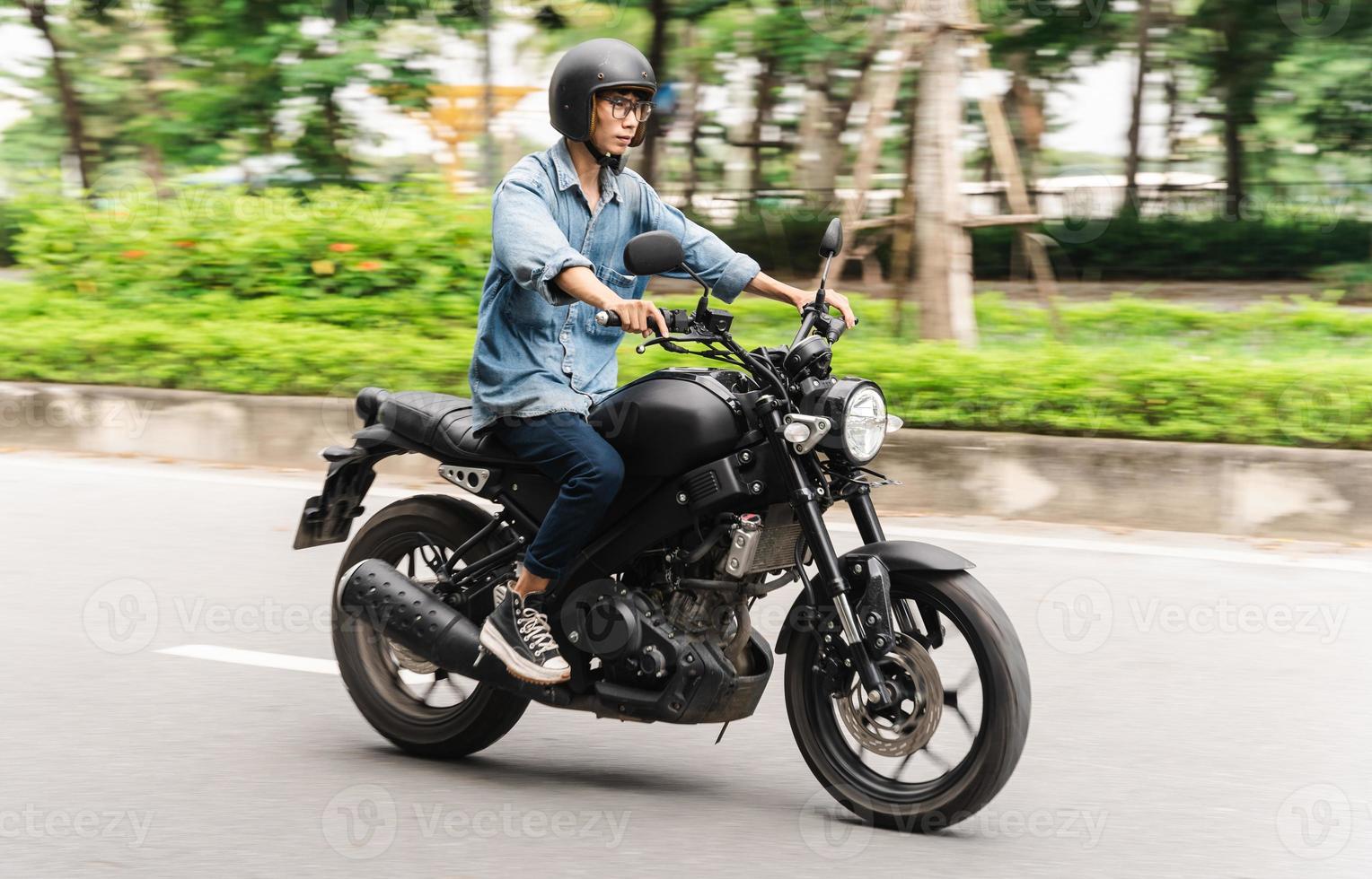 Image of Asian man driving on the street photo