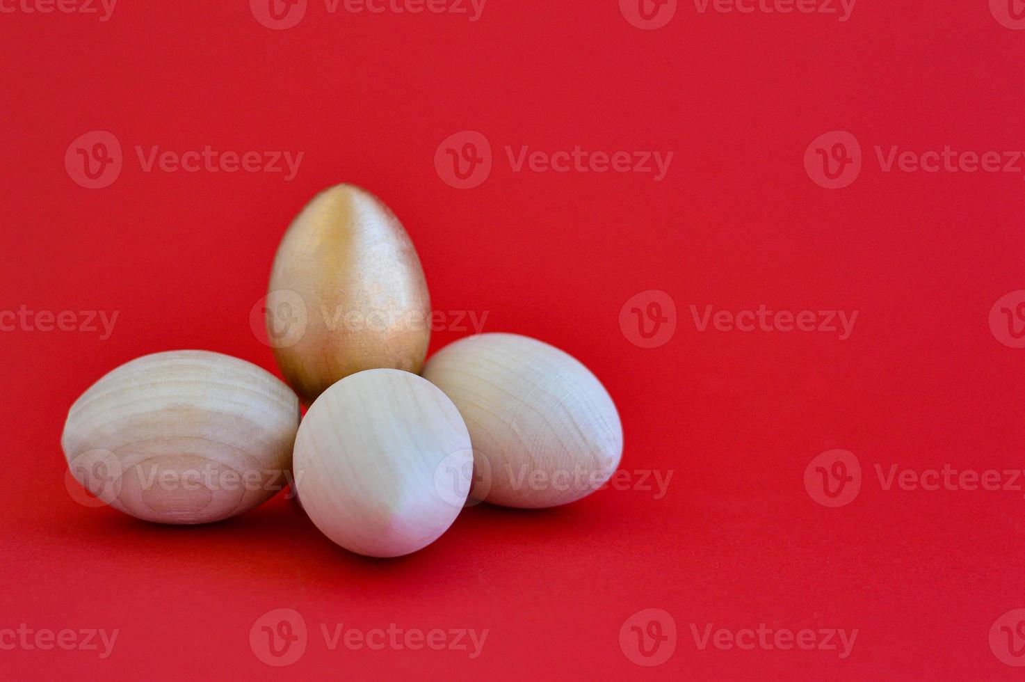 Wooden Easter eggs on a red background, a place for text, diy photo