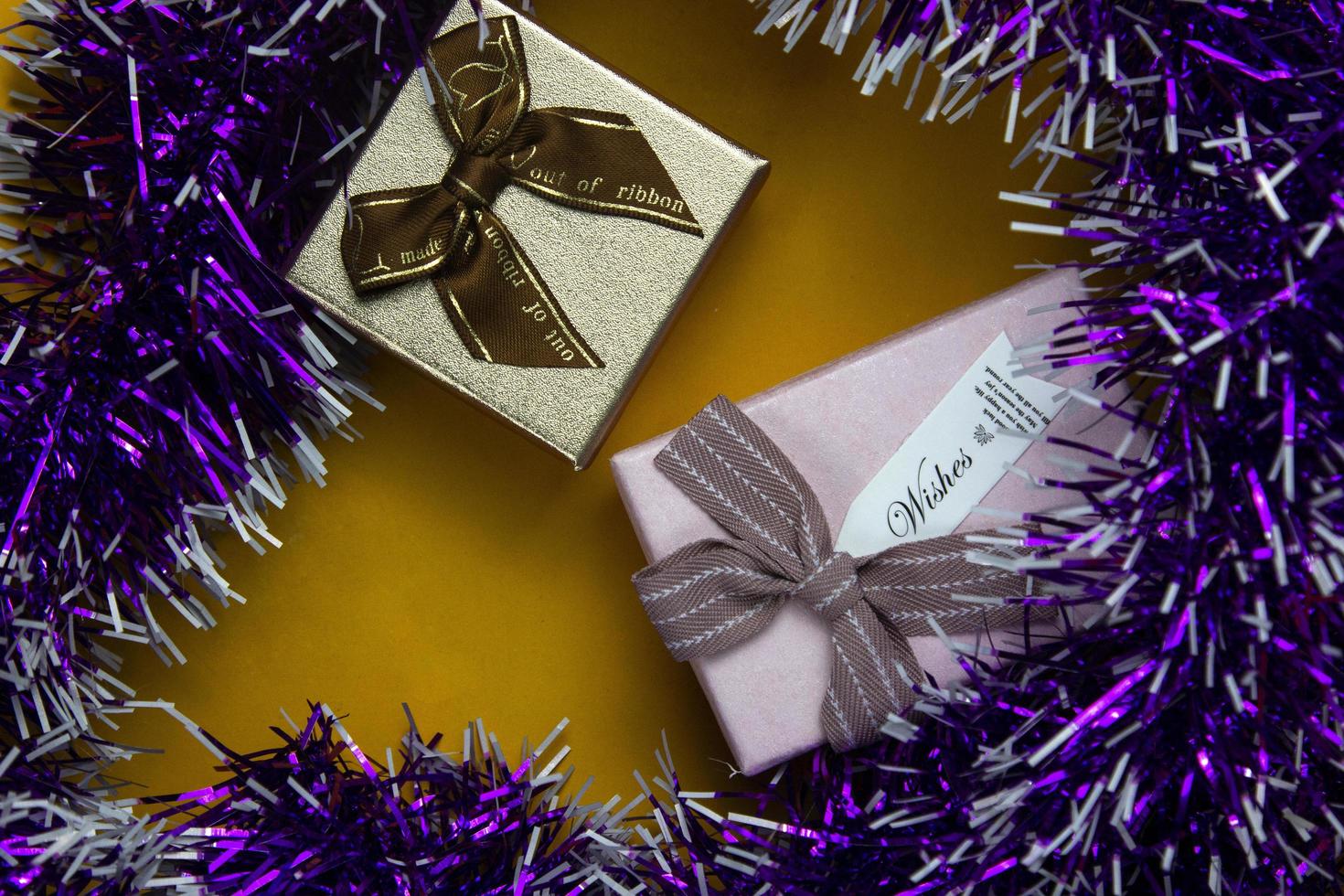 Gift boxes and ribbons place on yellow background, Two gift boxes used in celebration concepts design. photo
