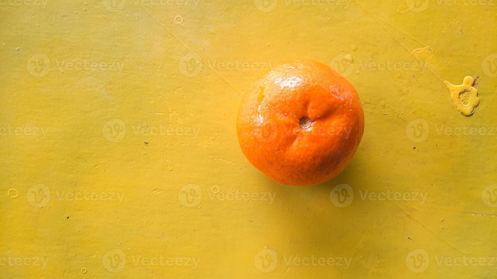 Top angle, Orange fruit on a yellow background 01 photo