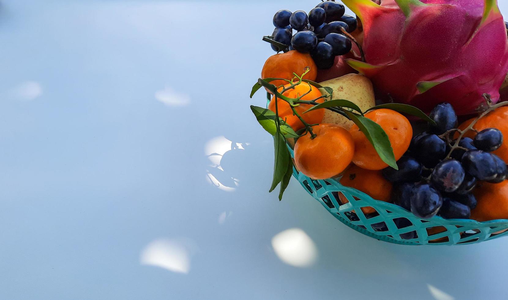 Tropical Dragon Fruit Oranges, pears, grapes on the right on a white background 01 photo