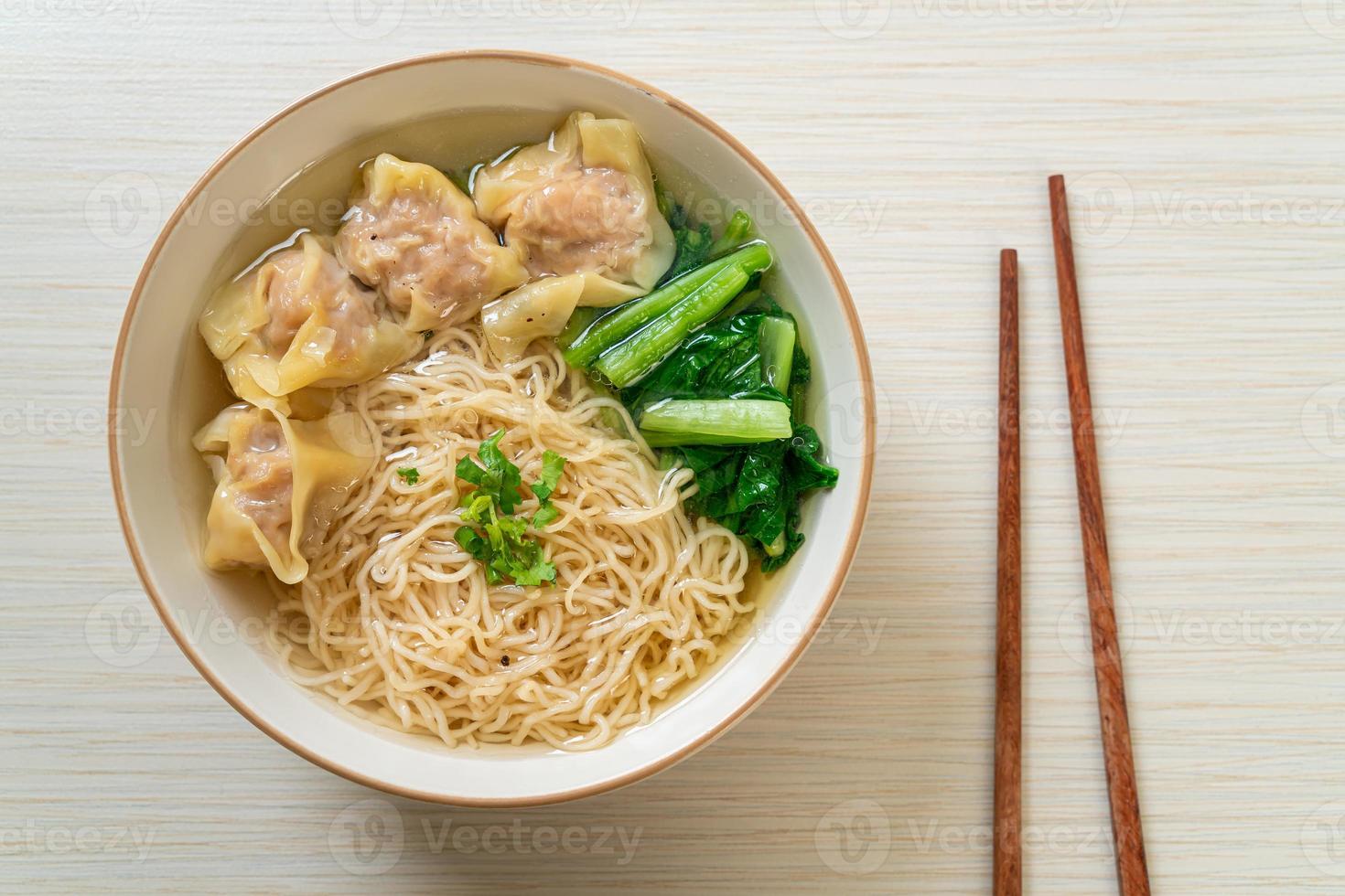 egg noodles with pork wonton soup or pork dumplings soup and vegetable photo