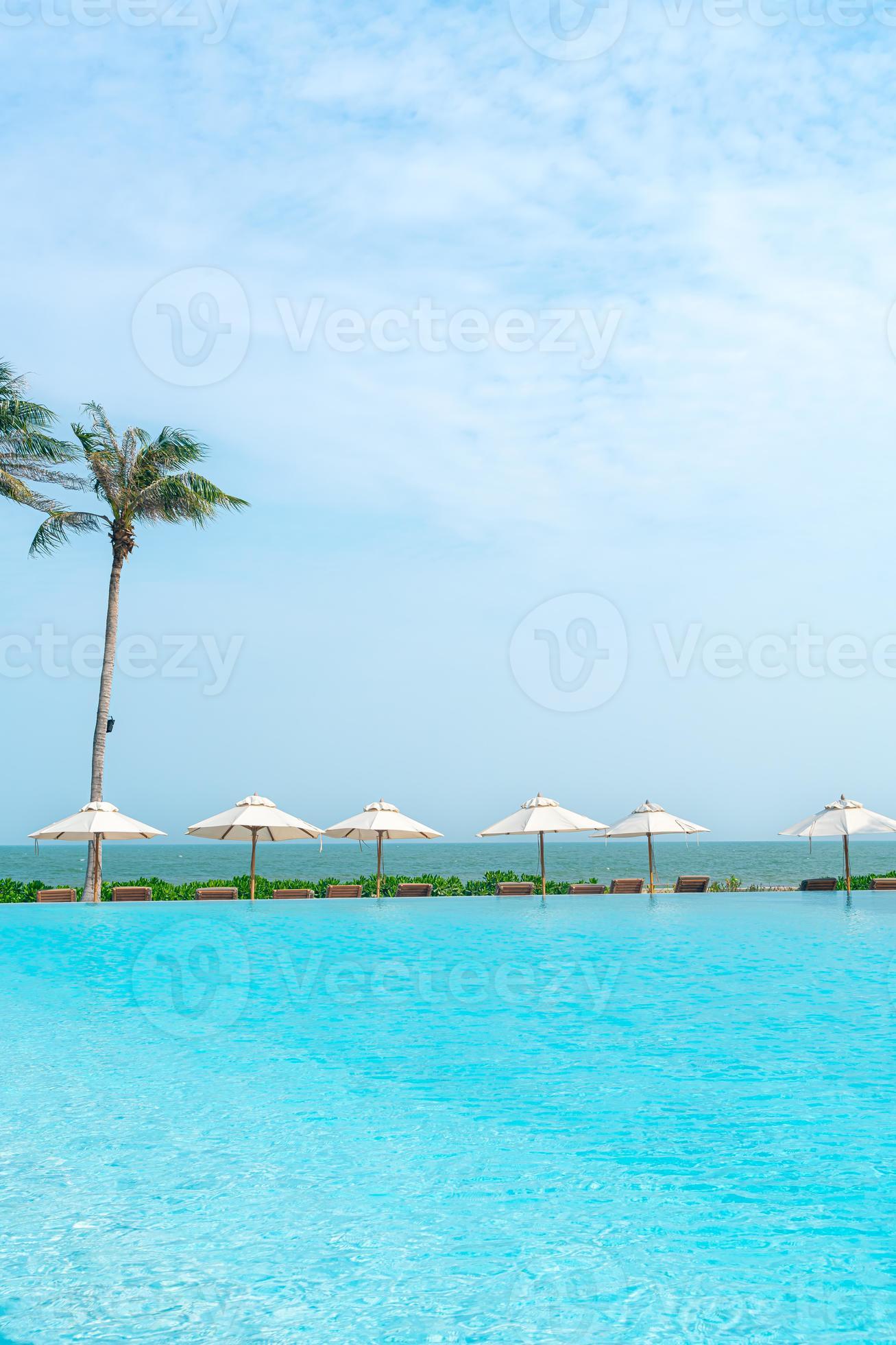 umbrella with bed pool around swimming pool with ocean sea background