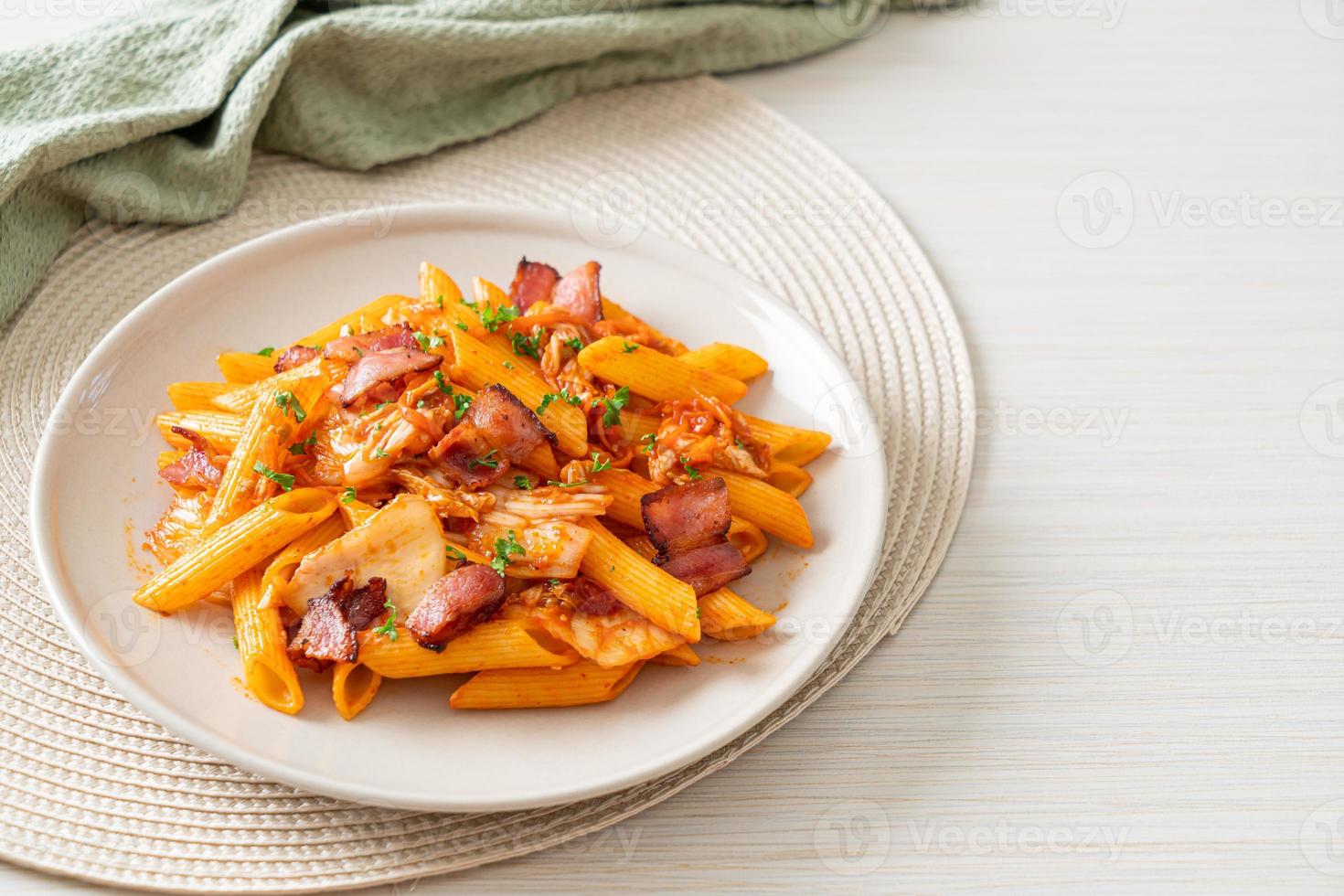 stir-fried penne pasta with kimchi and bacon photo