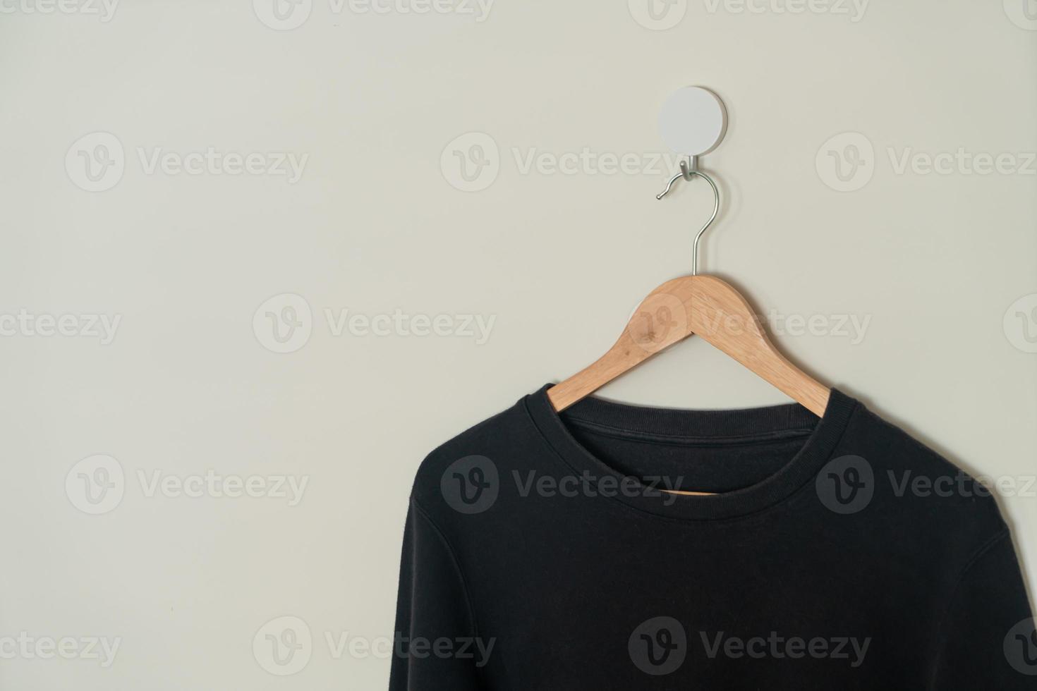 black sweater hanging on hanger photo
