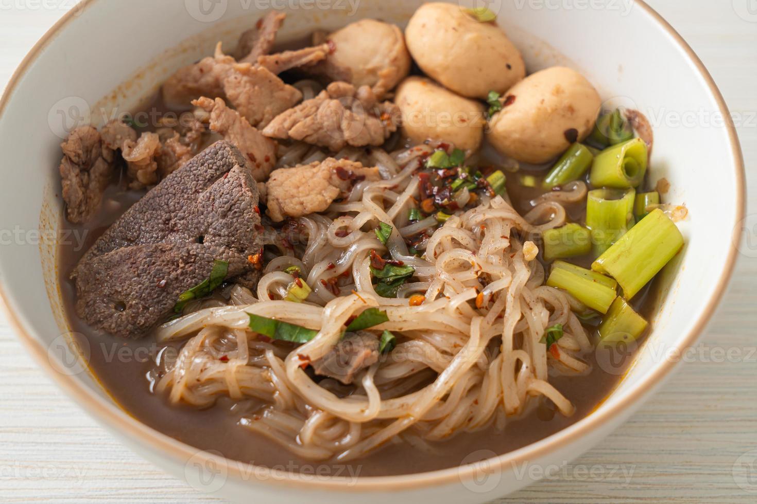 Thai noodle with pork, stewed pork, meatball and pork liver in blood soup photo