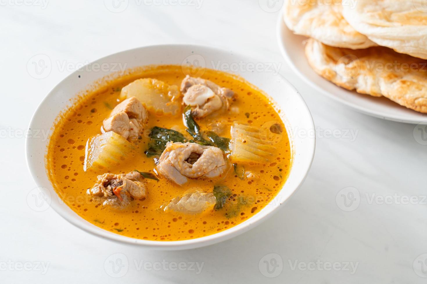 Chicken curry soup with roti photo