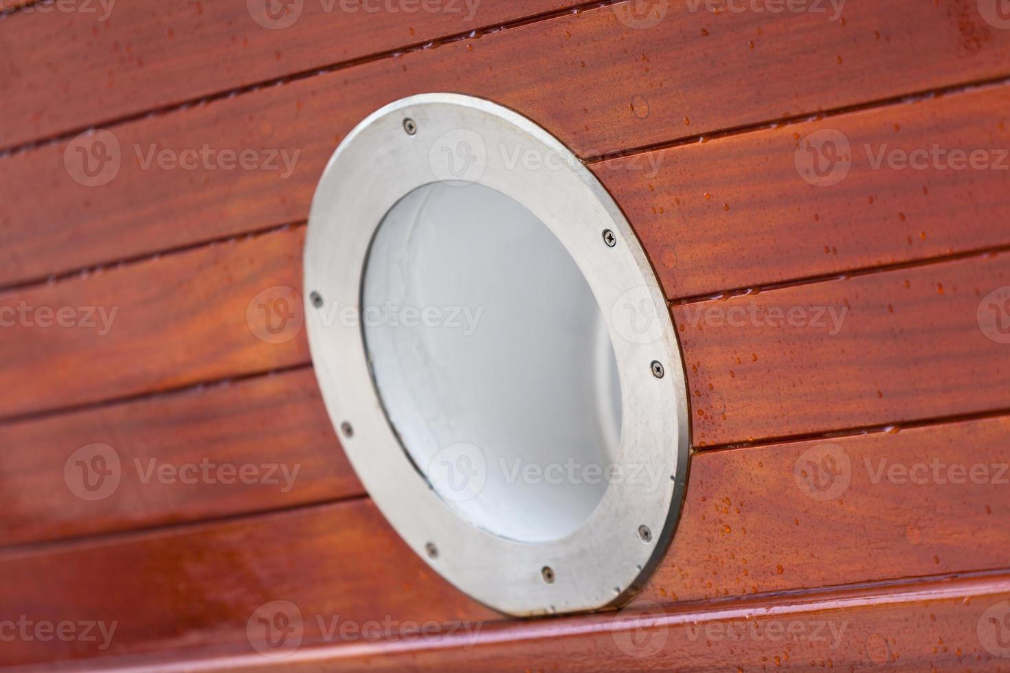 Wooden Ship porthole. View from outside photo