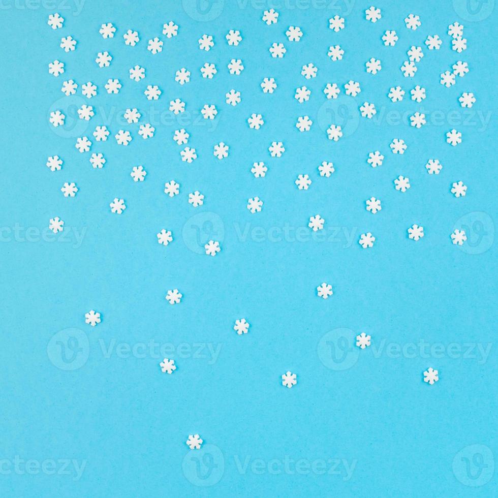 Winter pattern made of small white snowflakes photo
