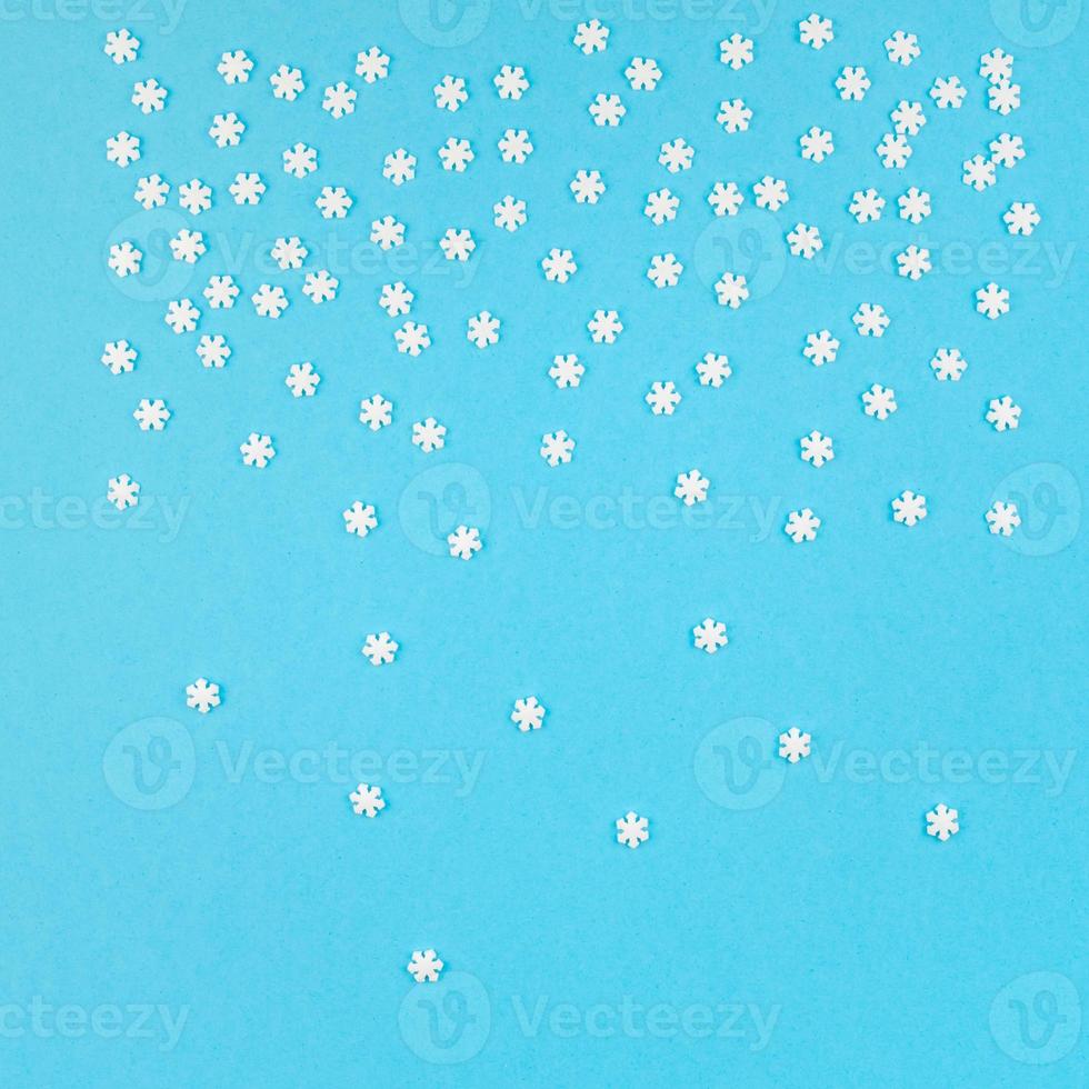 Winter pattern made of small white snowflakes photo