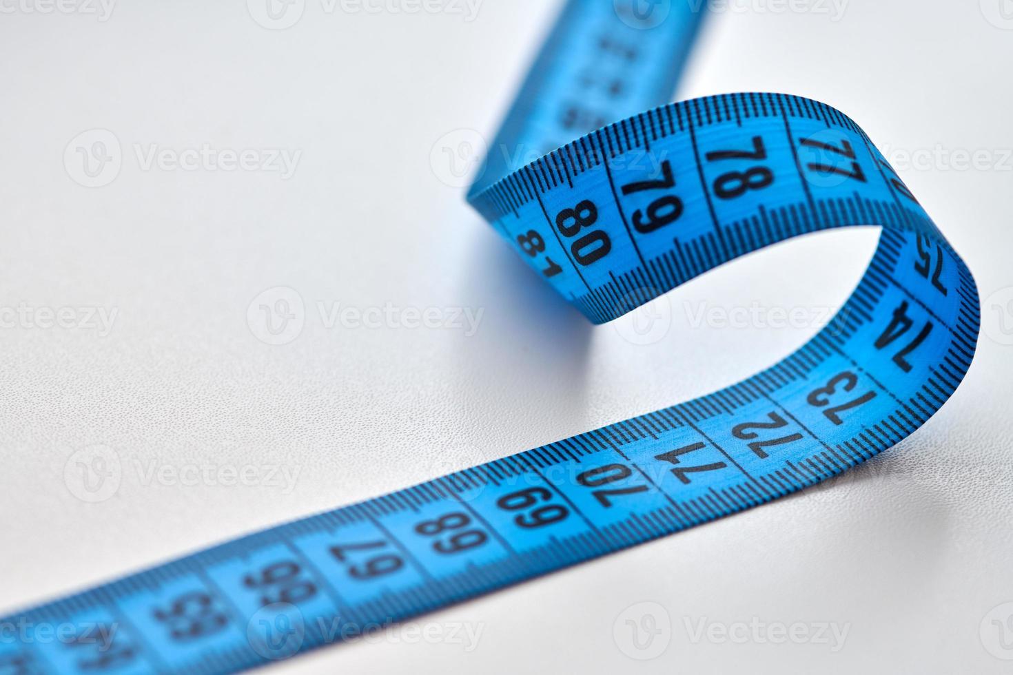 Blue measuring tape isolated on white background photo