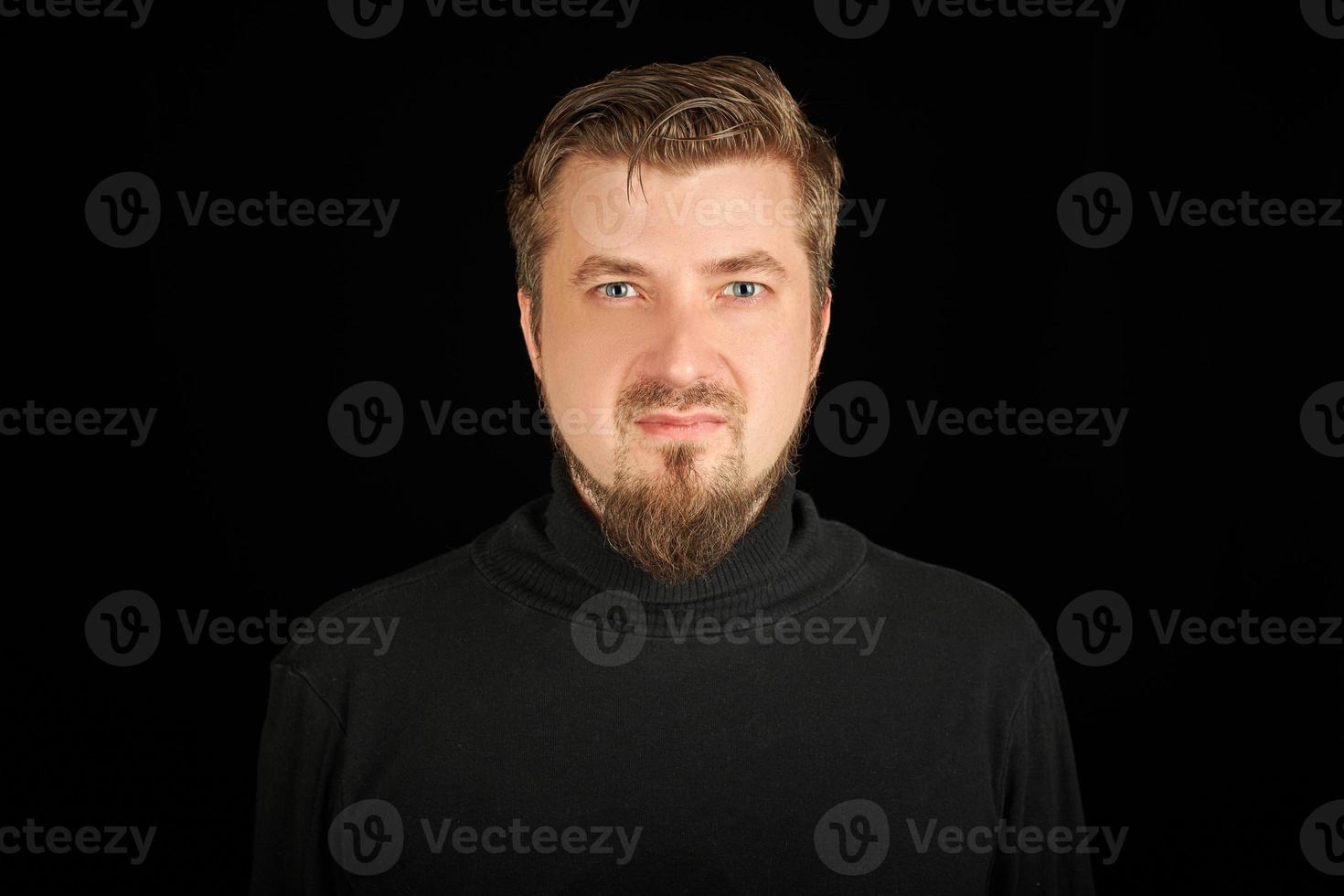 Cute bearded young guy in black polo neck sweater. photo