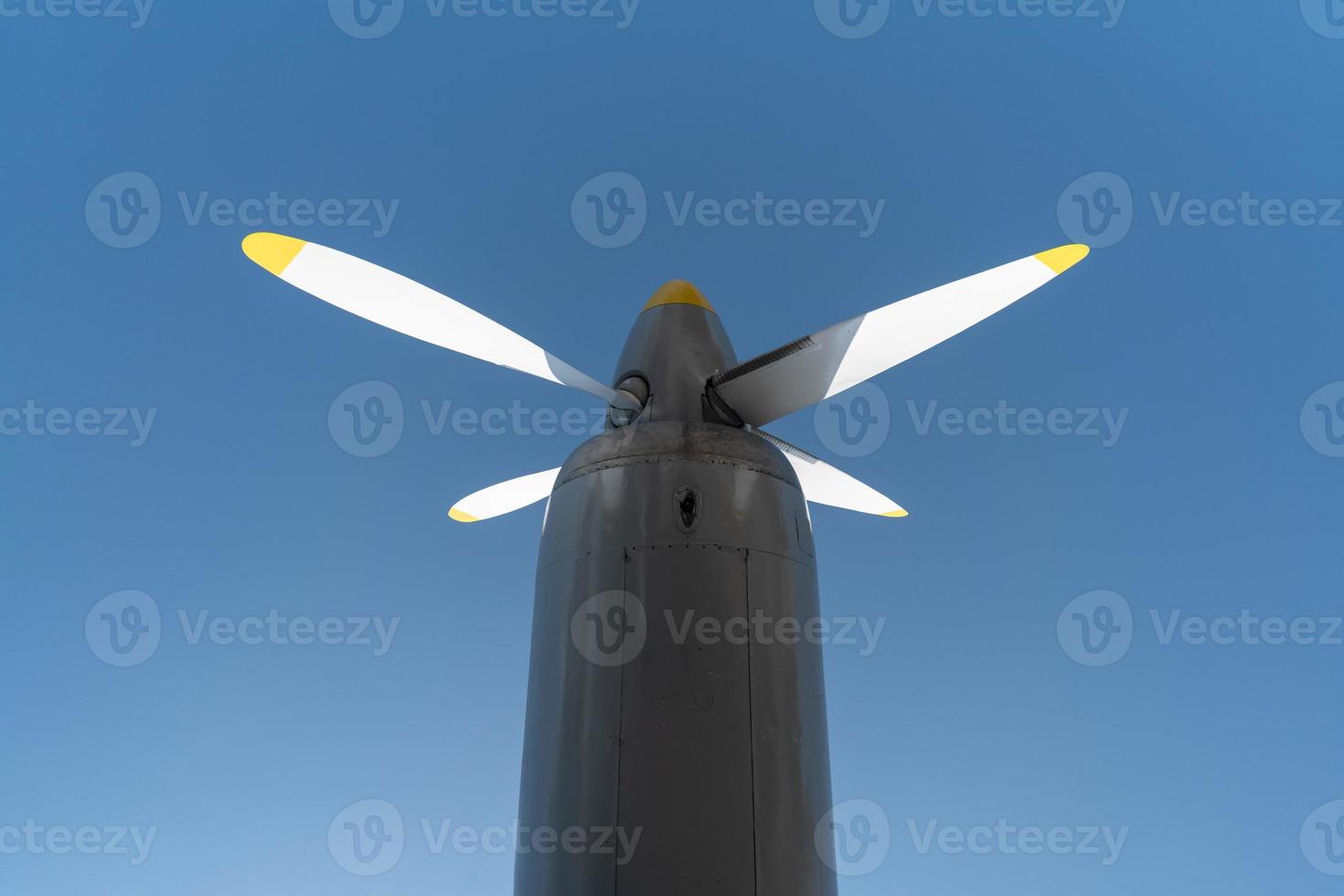 Airplane propeller of military aircraft, copy space. Blue sky sunny background. photo