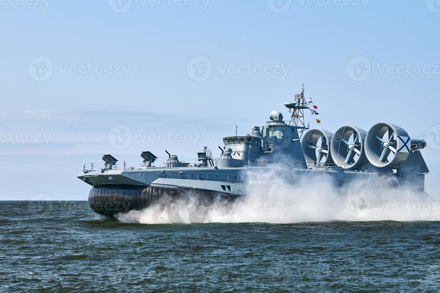 Landing Craft Air Cushion hovercraft flying above water, air cushion sailing splashing sea water photo