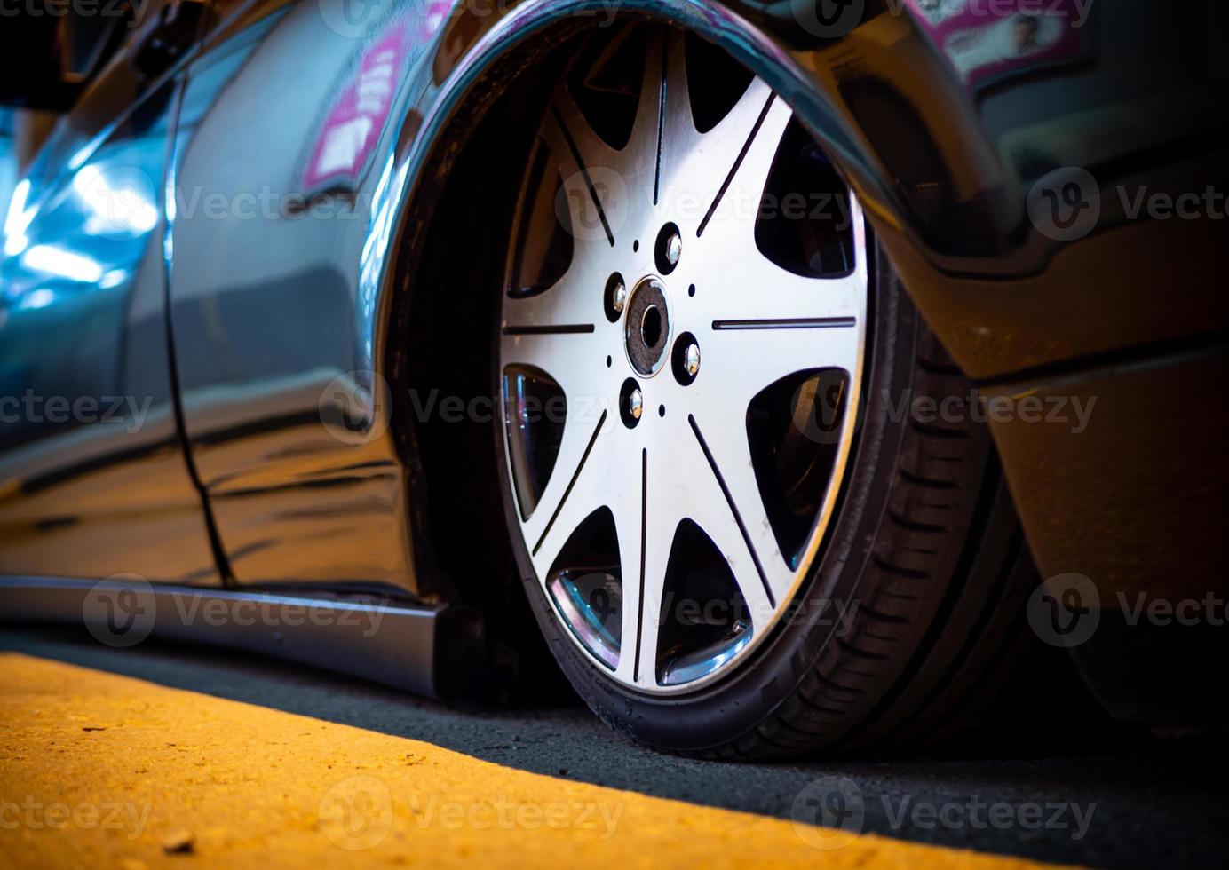 The car is parked on a night street close-up. photo