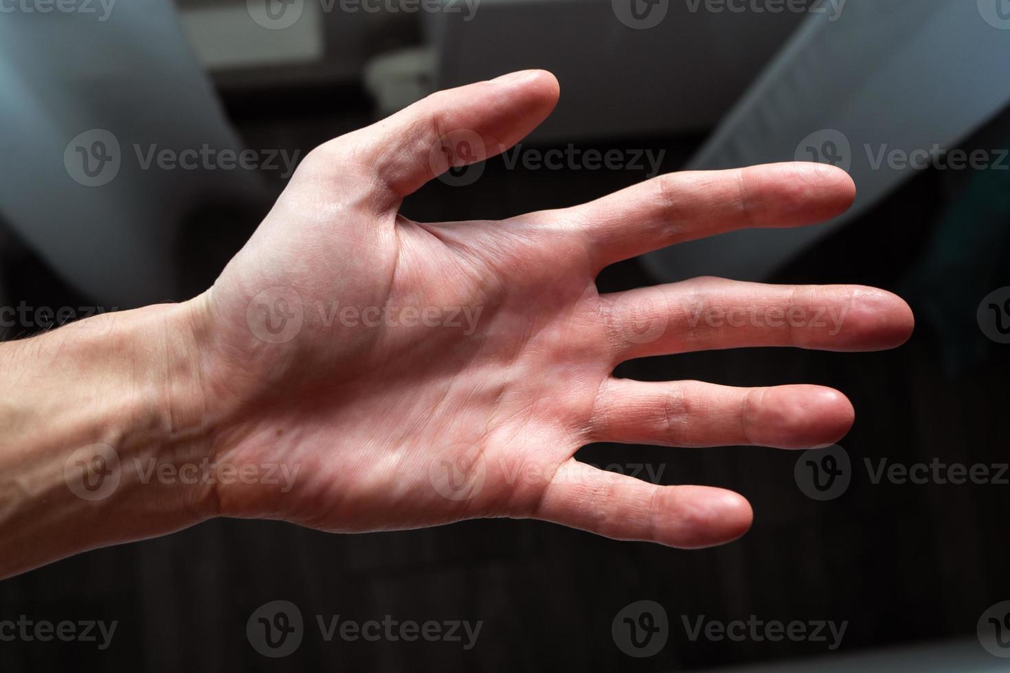 Close-up Of Human Hand Against Gray Background photo
