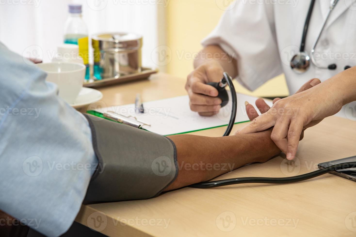 The doctor diagnos the patient' health in the hospital photo