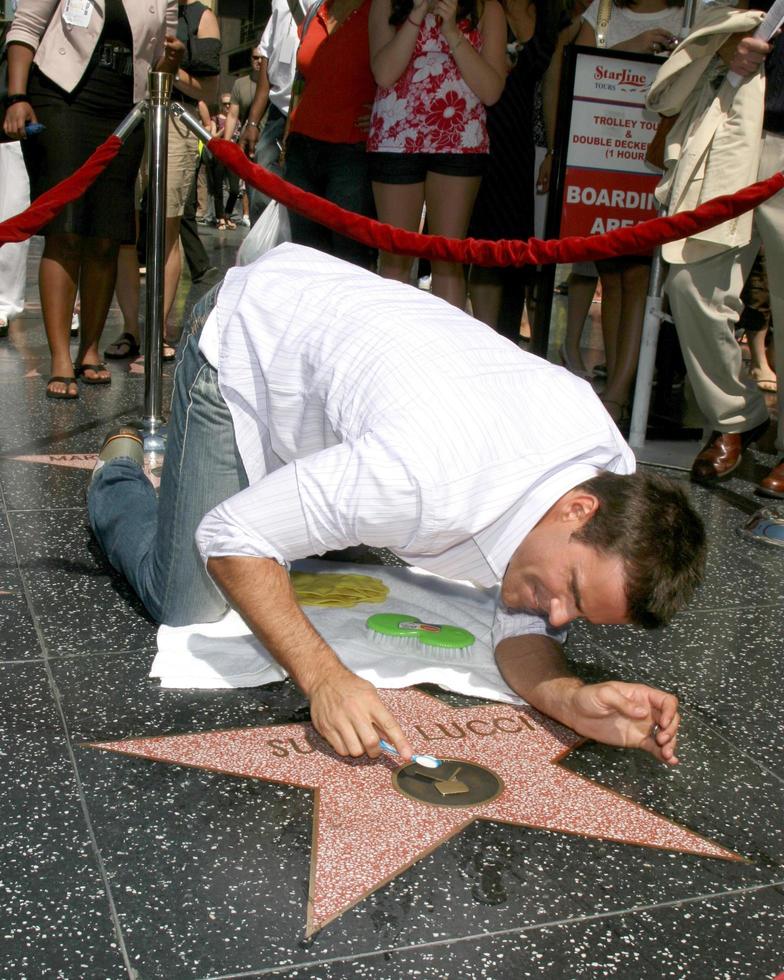 Cameron Mathison cleaning the Susan Lucci Star on the Hollywood Walk of Fame adjacent to the Kodak Theater piror to Daytime Emmys at the Hollywood and Highland complex in Hollywood, CA June 19, 2008 photo